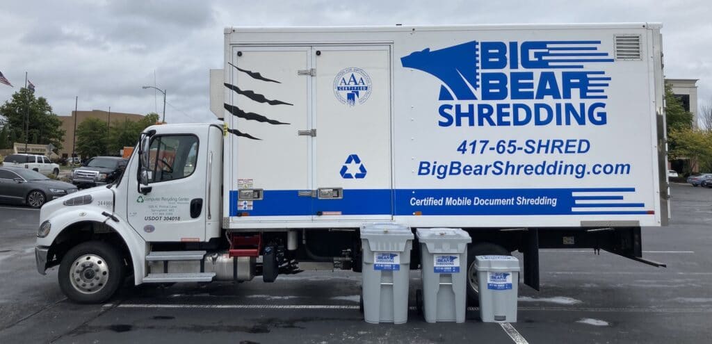 Big Bear Shredding Truck parked in a parking lot with our Shredding Containers lined up beside.