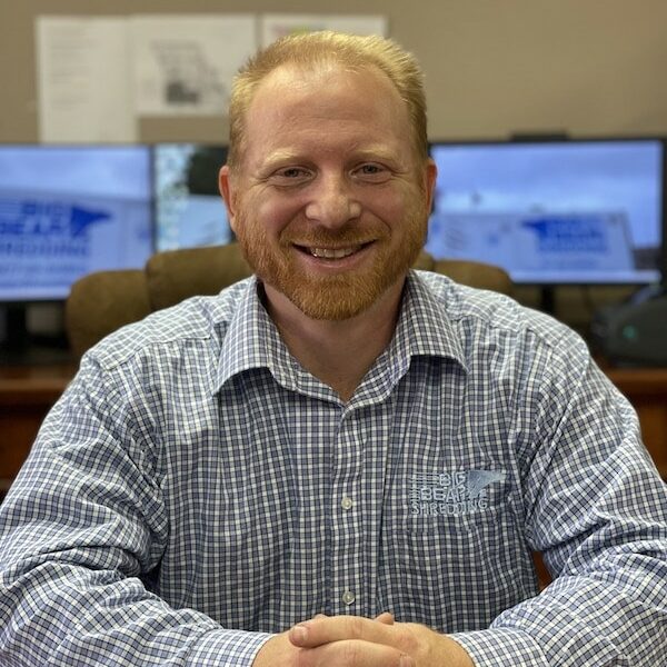 Big Bear Shredding Compliance Officer Travis sitting at desk with computer monitors behind him